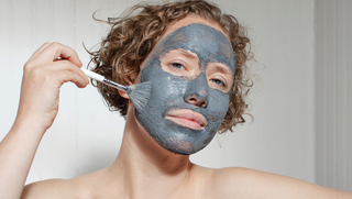 Woman apply Apoterra Charcoal Facial Mask