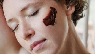Woman with Hibiscus Exfoliating Mud on her cheek