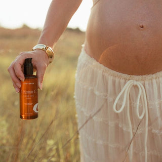 Pregnant woman holding Vitamin C Argan Oil (0U1A4472)