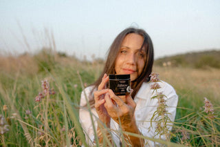 Woman holding product in field - 0U1A4908