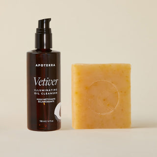 Apoterra Vetiver Illuminating Oil Cleanser bottle and Pumpkin & Wild Carrot Cleanser bar on a beige background