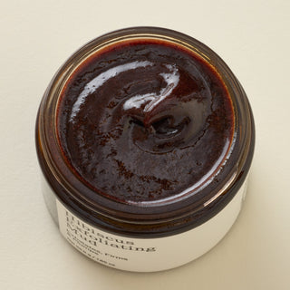 Exfoliating face mask top down view of burgundy texture
