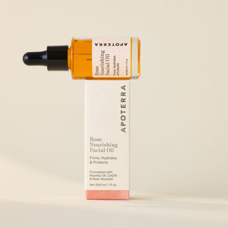 Rose Nourishing Facial Oil bottle stacked on Apoterra box with firms, hydrates & protects text. 