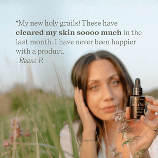 Woman holding Apoterra Sea Berry Balancing Facial Oil with customer review of clear skin overlay 
