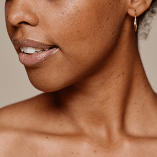 Close up image showing a woman's face and neck area