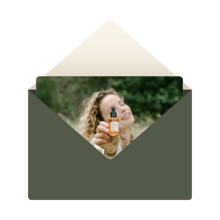 Green envelope with card picturing woman holding sea berry facial oil 