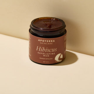 Apoterra Hibiscus Exfoliating Mud Mask in travel-sized jar showing luxurious & rich texture