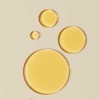 Niacinamide serum droplets on a neutral surface showing rich color