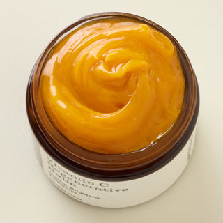 Apoterra Vitamin C Balm image from the top showing deep, rich orange texture