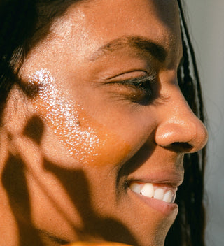 Vitamin C Regenerative Balm by Apoterra application on cheek for glowing hydration 