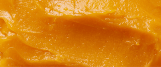 Macro texture shot of Vitamin C Regenerative Balm featuring vitamin C, cupuacu butter, and sea buckthorn berry oil