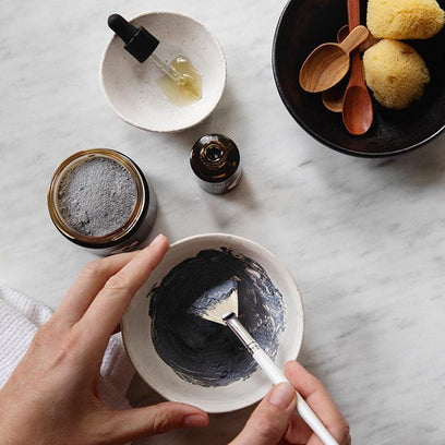 Mineral Purifying Mask by Apoterra mixing powder and ingredients in bowl for application preparation 