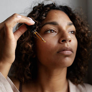 Rose Nourishing Facial Oil by Apoterra facial application to cheek by model